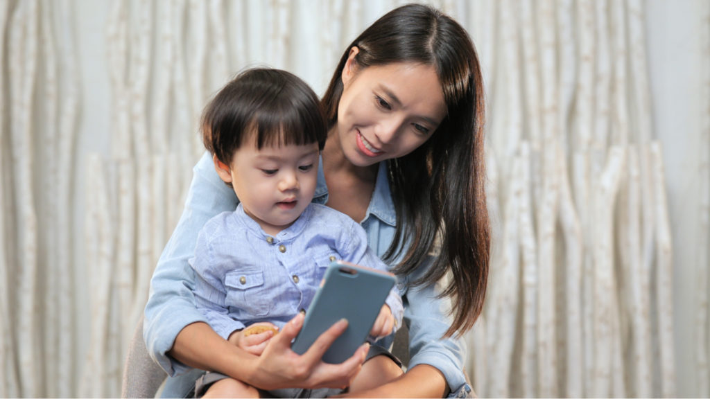 Mother with her child using the smartphone
