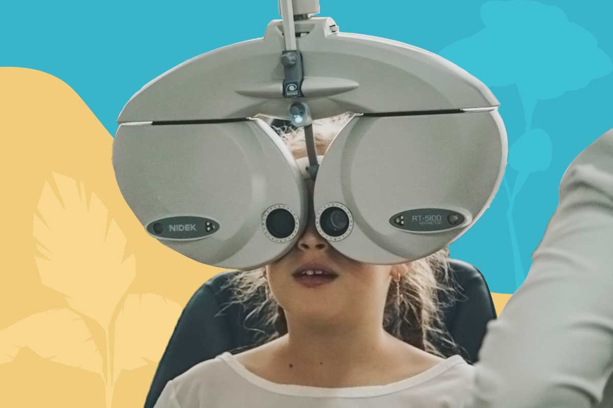 young girl with the optometrist machine making an eye test