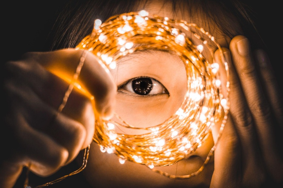 girl with a light cable checking her eye shape