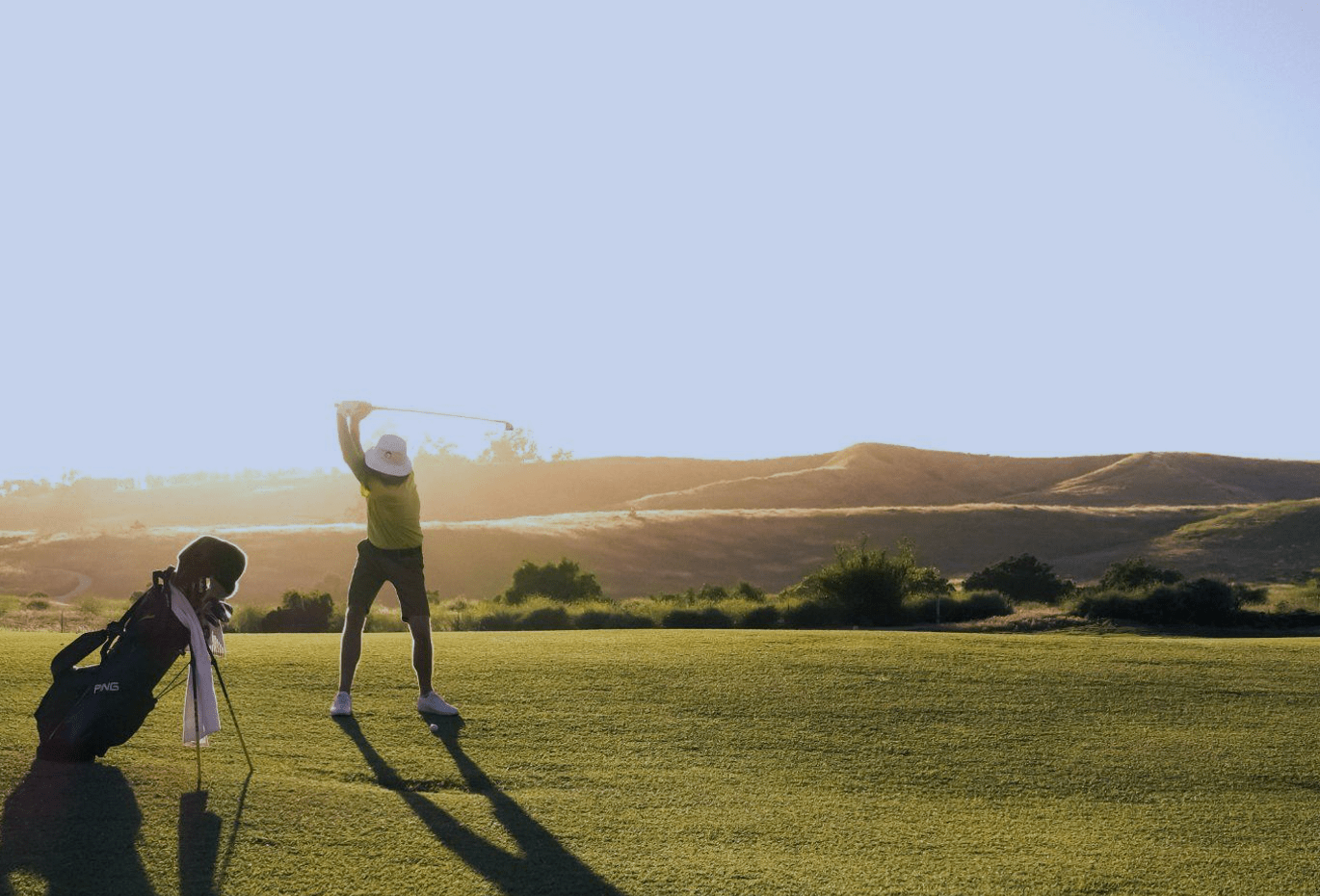 children playing golf in Singapore in a green hill