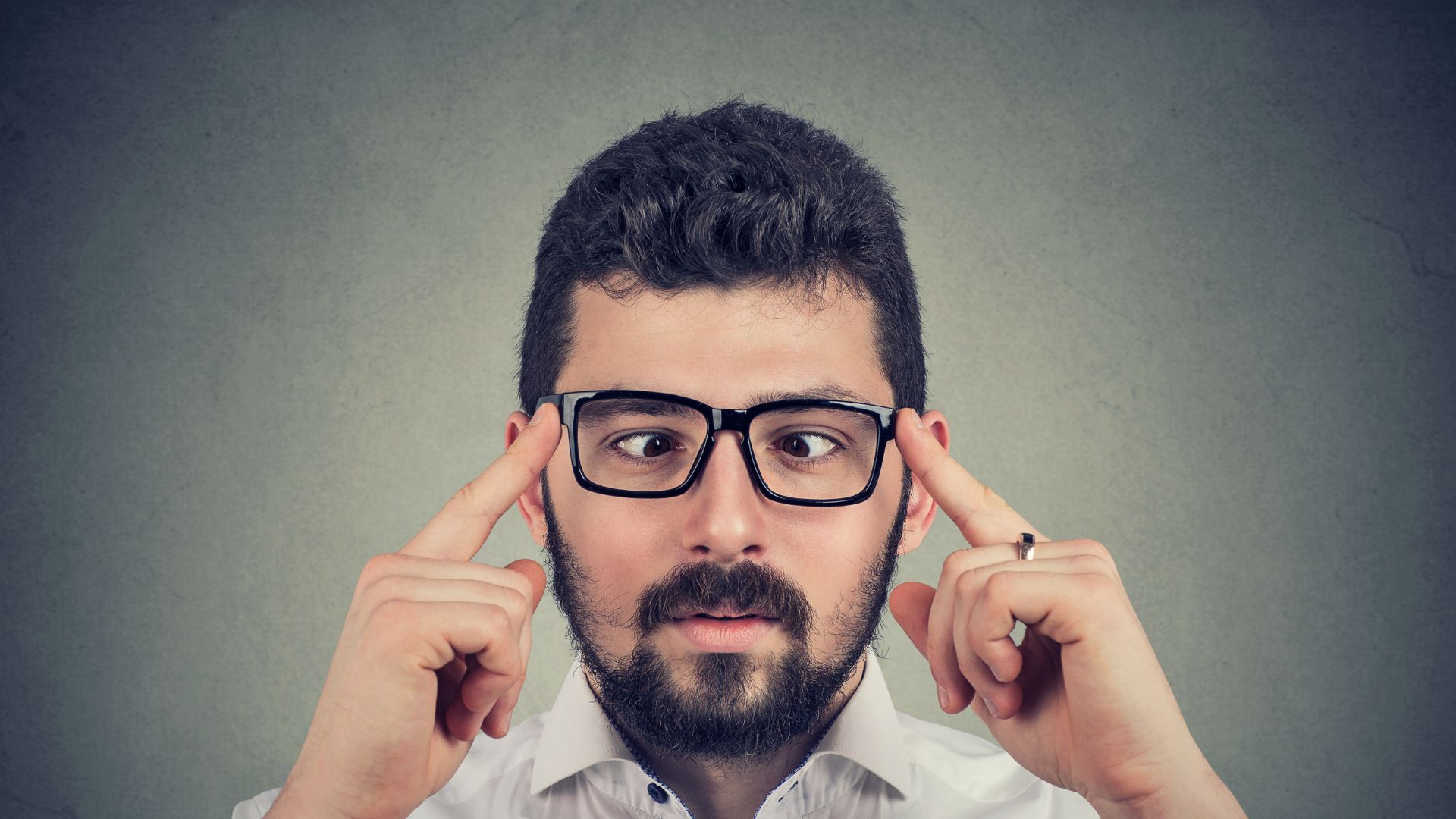 Man with black glasses with strabismus